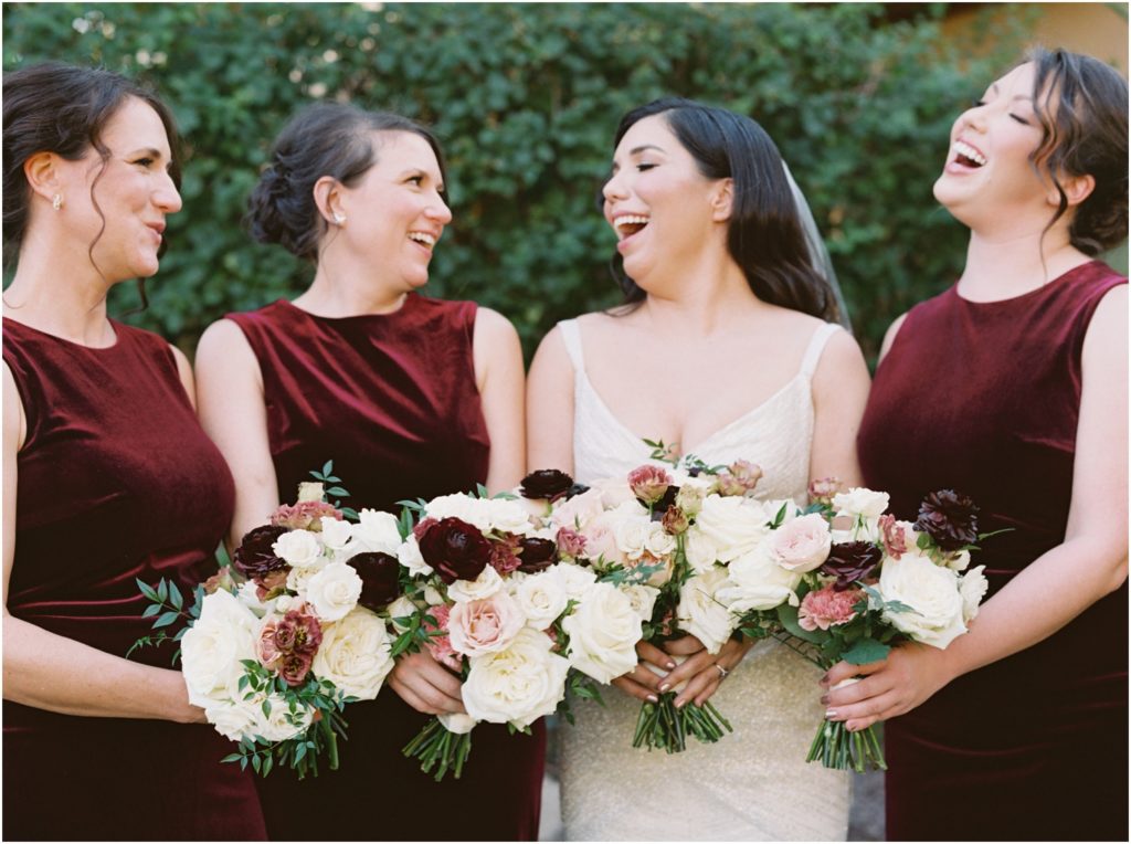 bride with bridesmaids wearing burgundy dresses
