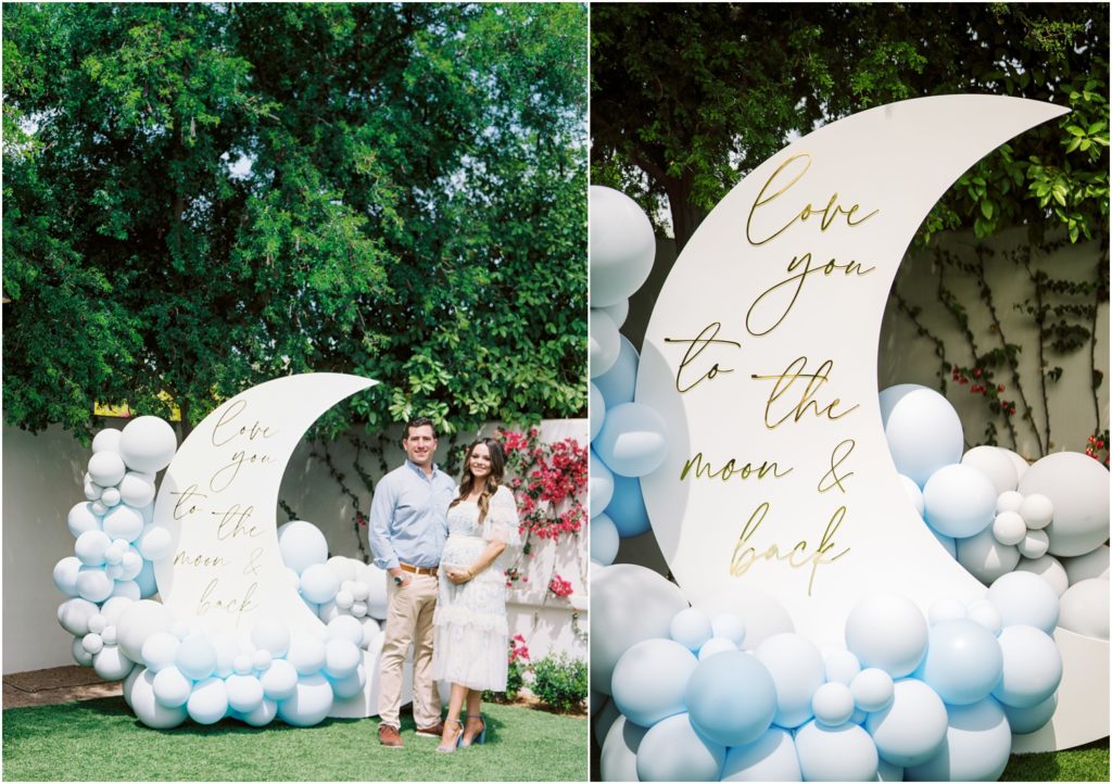 large moon shaped photo backdrop with blue balloon installation at moon and stars themed baby shower